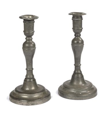 pair of silver candlesticks on a white background