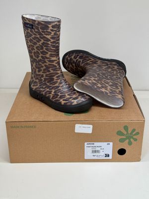 leopard print rain boots on a cardboard box on a white surface