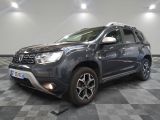 La Dacia grise est garée dans une grande pièce au sol carrelé en damier.
