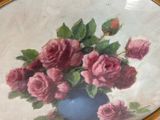 a painting of pink roses in a blue vase on a table