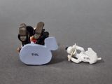 toy figurines of a man and a woman in a small plane