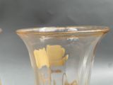 two vases that are sitting on a table