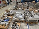 a large amount of metal items on pallets in a warehouse