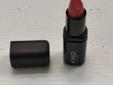 a red lipstick that is sitting on a table