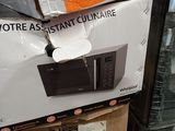 boxes stacked on top of each other with a microwave on top of it