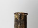 a brown vase that is sitting on a table