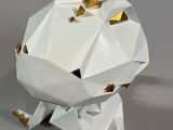 a paper origami of a dog with a crown on its head