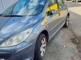 the grey car is parked in front of a building