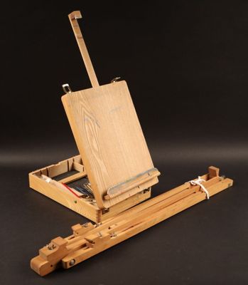 an artist ' s easel with a piece of wood on it