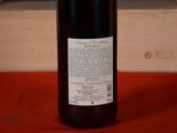a bottle of wine sitting on a table next to a wooden box
