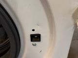 a close up of a washing machine with the door open