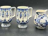 three blue and white vases sitting next to each other on a table