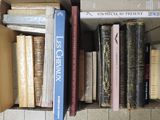 many books that are in a box on the floor