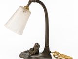 an old fashioned lamp with a glass shade and a pair of scissors