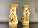 two vases that are sitting on a table