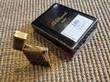 an image of a box of perfume sitting on top of a carpet