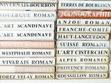 many books stacked on top of each other on a table