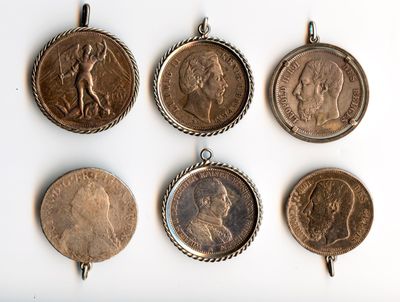 several different types of coins are displayed on a white surface