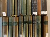 several books are stacked on top of each other on a shelf