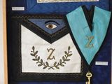 a picture of a blue and white apron with a key on it
