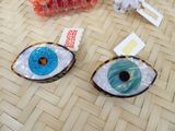 two donuts with blue eyes on them on a table