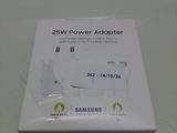 the box of the samsung power adapter is open on the table