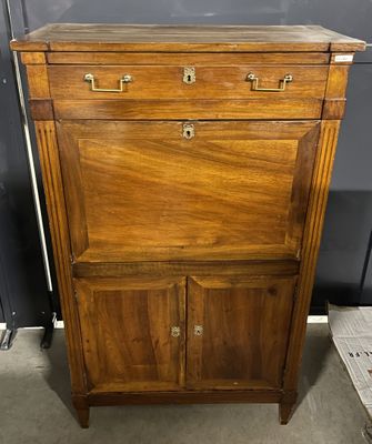an old wooden cabinet with two drawers and a drawer underneath it