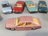 several toy cars are lined up in a row on a table