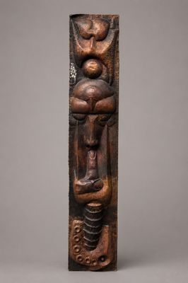 a wooden sculpture of a woman holding a child