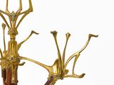 an image of a brass and wood tree on a white background