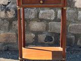 a small wooden table with a shelf on it