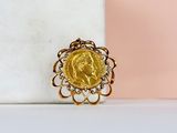 an image of a gold coin ring sitting on top of a marble block