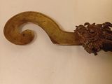 a wooden handle with a dragon head on it