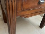 a small wooden table with a drawer on top of it
