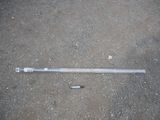 a baseball bat laying on the ground next to a bottle of beer