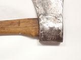 an old axe with a wooden handle on a white surface