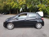 a picture of a small black car parked in a parking lot