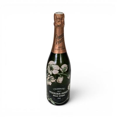 a bottle of champagne with flowers on it on a white background