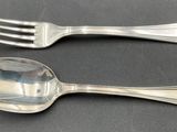 two spoons and a fork on a table