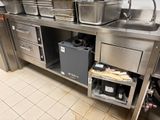 a large stainless steel kitchen with a lot of pots and pans
