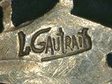 a close up of a gold medal with the word gautrad on it