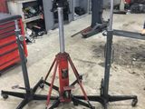 two jack stands in a garage with tools on them