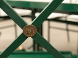 a close up picture of a green bench with a coin on it