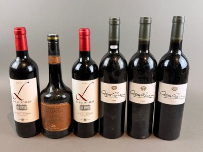 six bottles of wine are lined up in a row on a table