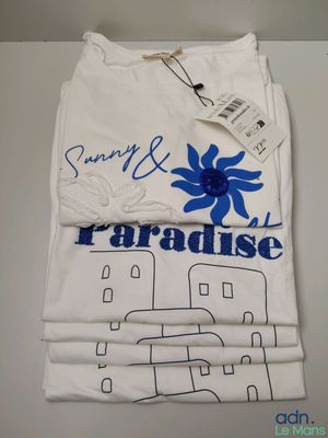 white t - shirt with a blue flower on the front of it