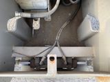 an overhead view of a metal box with a couple of pipes in it