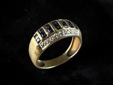 a close up of a gold ring with diamonds on a black background