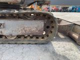 an image of a close up of a bulldozer in a parking lot