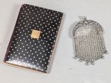 a small purse and a chain purse on a table