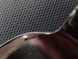 a close up of a metal spoon on a table